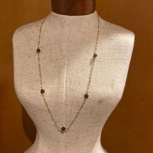 Gold tone necklace with green beading